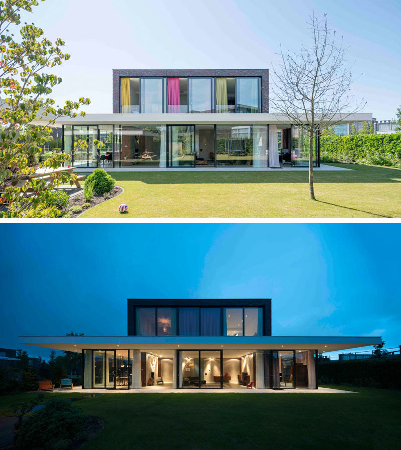 At the rear of this home, the large sliding glass doors and windows expose the interior of the home, allowing for natural light to flood the spaces.