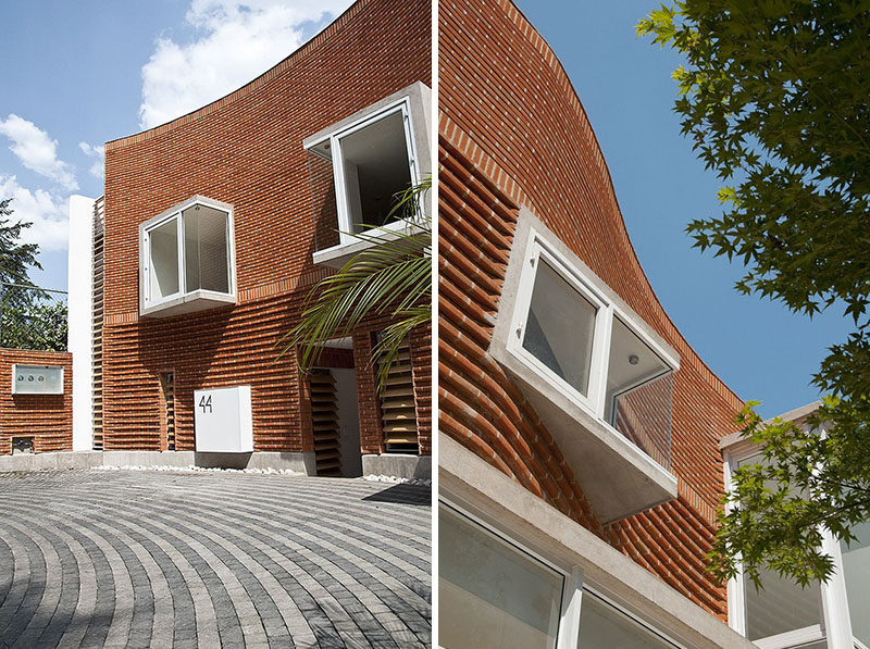 The bricks on this house have been arranged in a curved wave-like design.