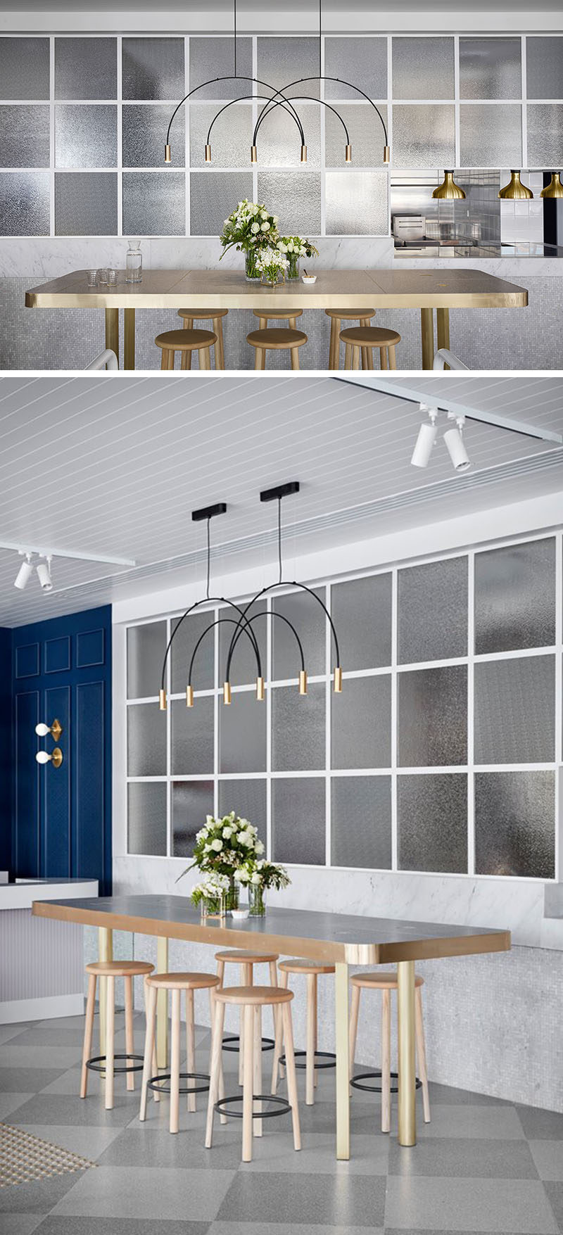 Above this table in a cafe is a delicate and sculptural pendant light, and beside it, framed textured glass windows hide the kitchen from the main area of the cafe