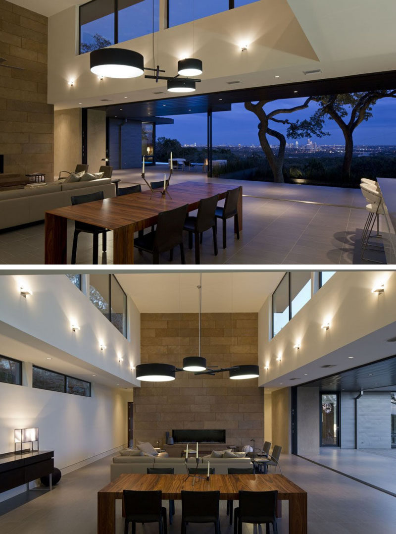 This dining room separates the living area and the kitchen, and is anchored by a large artistic pendant light.