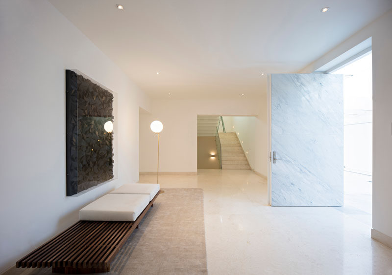 Inside this home, the entryway has been kept simple with an art piece and a bench.