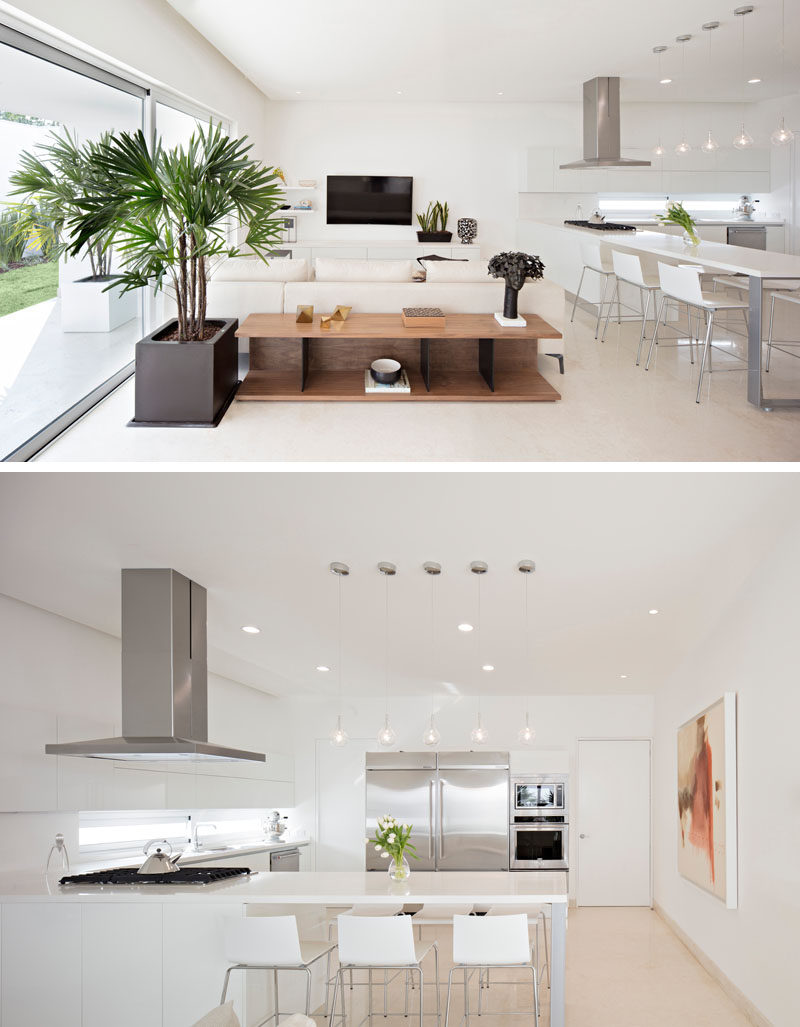 In this modern house, all of the public spaces are located on the ground floor of the home. A casual living room is located next to the kitchen that has a built-in dining table.