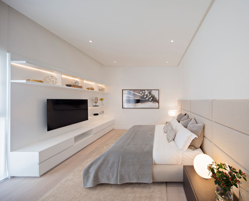 In this bedroom, horizontal lines have been used throughout in the headboard and wall storage unit helping to make the room feel larger.