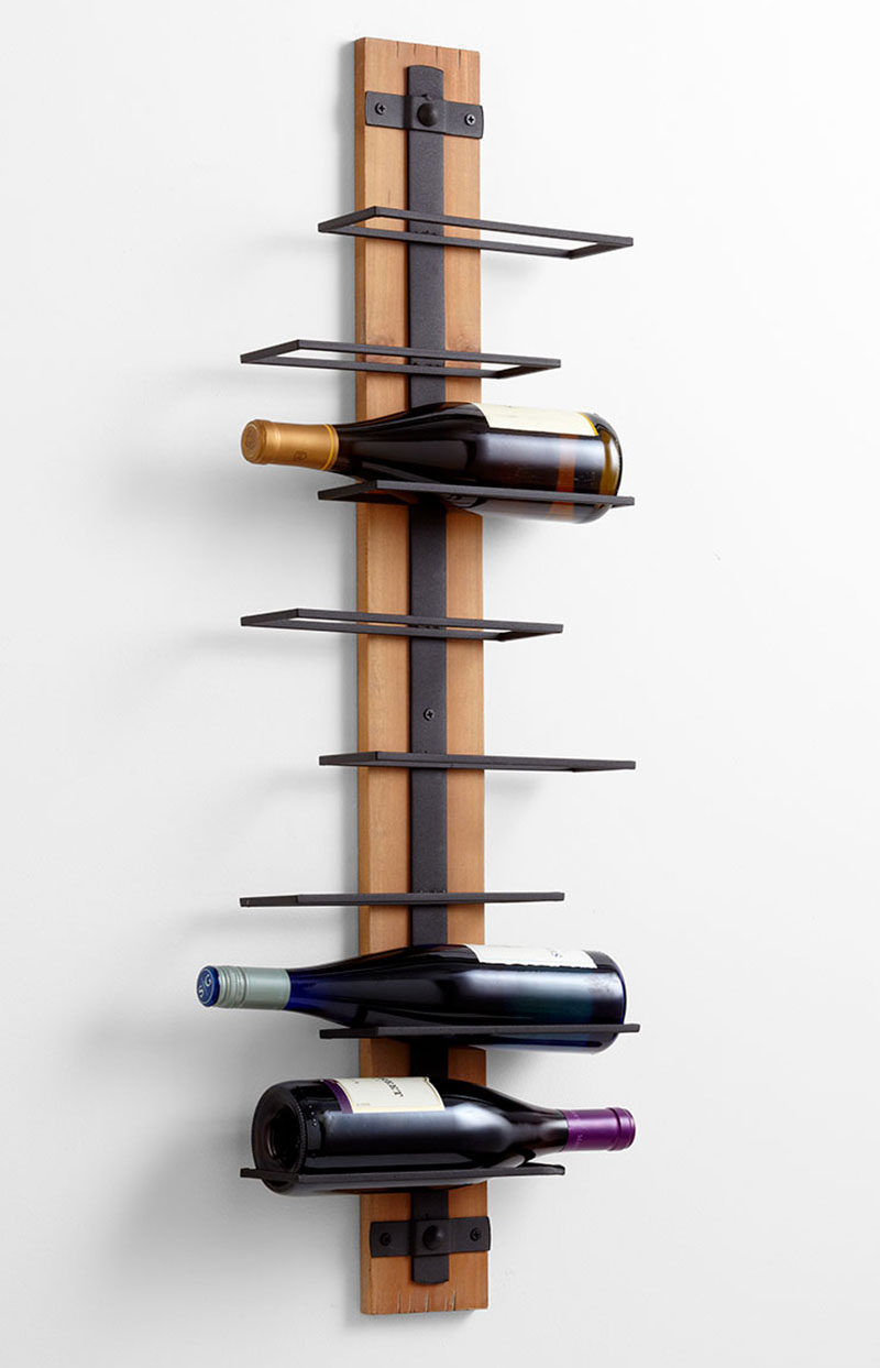 13 Wine Bottle Storage Ideas For Your Stylish Home // this wall mounted wine rack lets you make use of extra space on your walls but has the added bonus of letting you see exactly which wine you're grabbing without having to pull them all out.