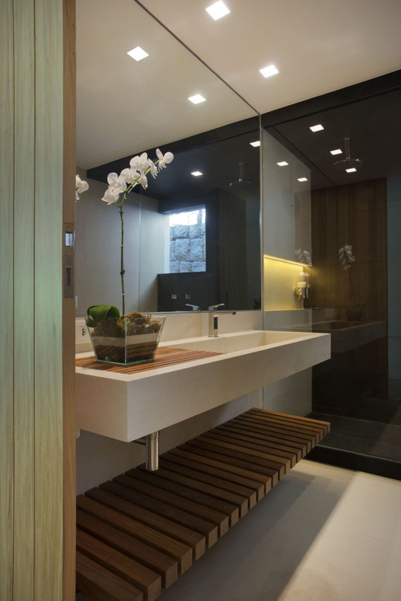 Bathroom Design Ideas - Open Shelf Below The Countertop // The tiny gaps between the pieces of wood making up this bathroom shelf make sure that if water does make it's way down there, it won't pool and soak whatever you have sitting on the shelf.