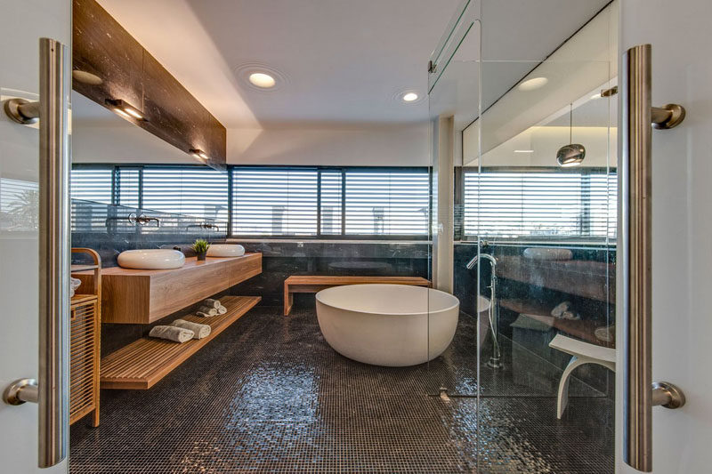 Bathroom Design Ideas - Open Shelf Below The Countertop // A shelf underneath your bathroom counter eliminates the need to store your towels in a linen closet away from the bathroom and makes sure you never have to call for someone to bring you a towel.