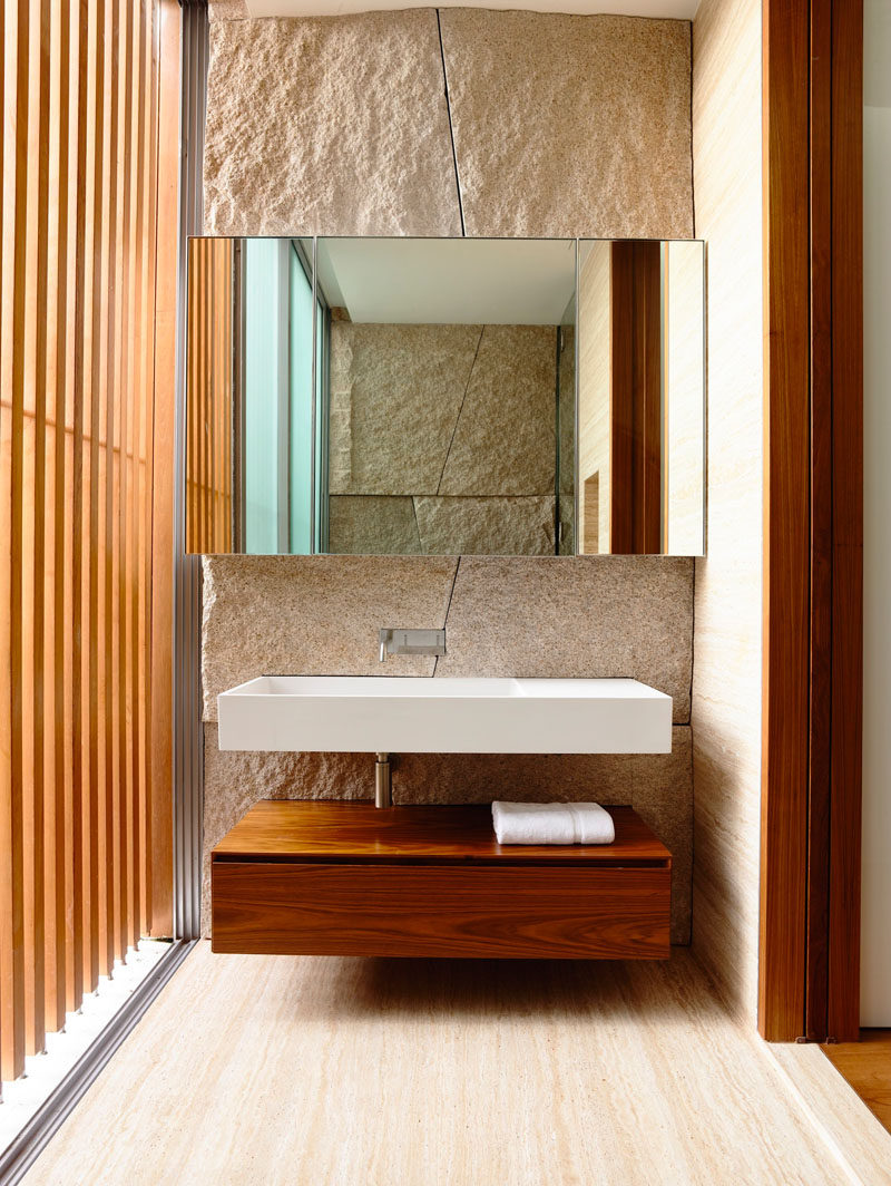 Bathroom Design Ideas - Open Shelf Below The Countertop // The shelf under this clean white sink also has a drawer so you can keep your pretty towels out but hide your toilet paper and other less visually appealing things in the drawer.