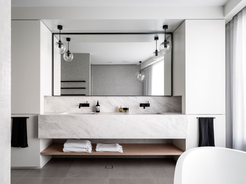 Bathroom Design Ideas - Open Shelf Below The Countertop // The little bit of wood included in this bathroom in the form of an under the sink shelf adds just enough warmth to the space to keep it from feeling cold and uninviting.