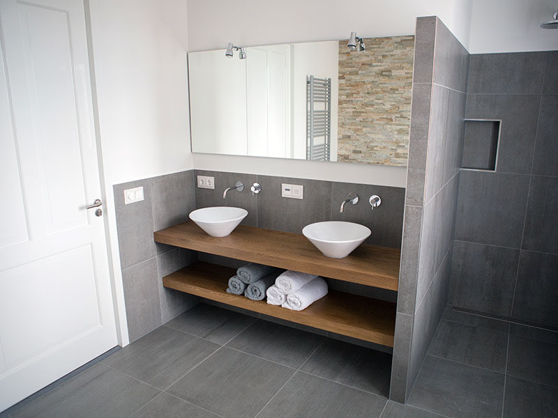 Bathroom Design Ideas - Open Shelf Below The Countertop // This bathroom predominantly covered in stone tiles but is warmed up with the wood counter and shelf that give it a modern and inviting look.