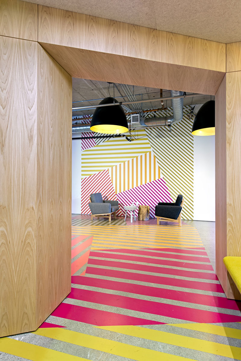 Interior Design Idea - This office design has a colorful geometric pattern that flows from the wall to the floor, and is inspired by the colors of the tulip fields in the Netherlands.