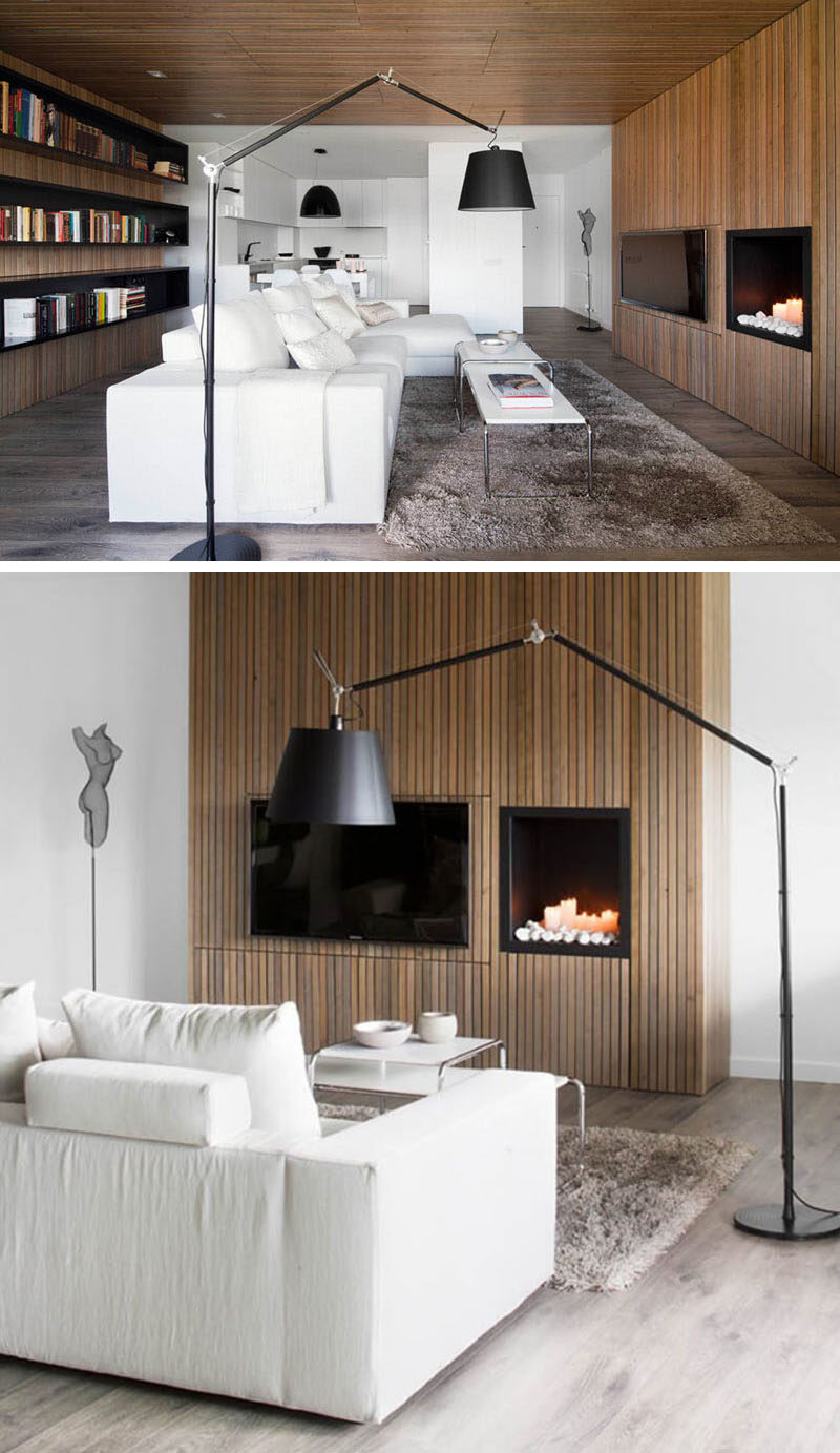 8 TV Wall Design Ideas For Your Living Room // Having your TV next to the fireplace also helps to create a cozy atmosphere that’s perfect for enjoying a movie while cuddled up on the couch.