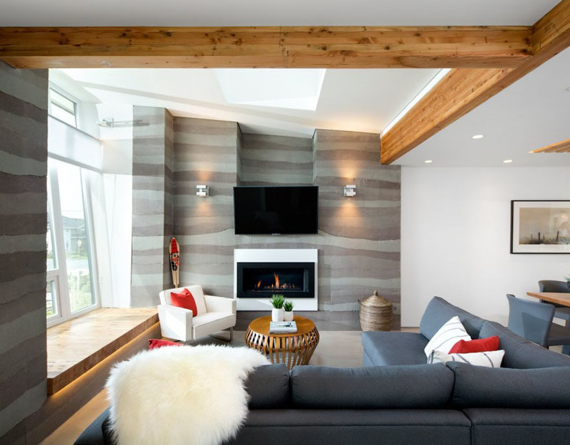 8 TV Wall Design Ideas For Your Living Room // This TV sits just above the fireplace to create a cozy viewing experience.