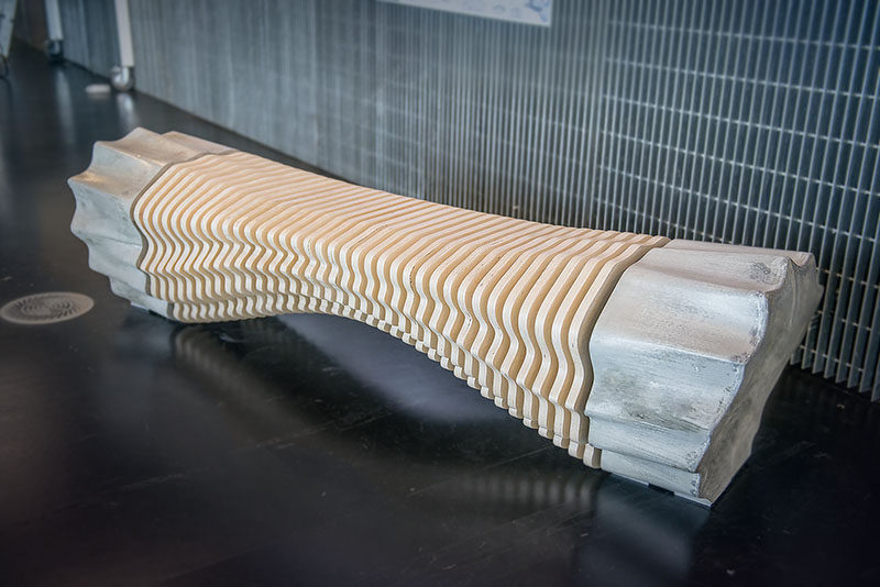 Industrial design student Tianzhu Zhang, has created an industrial inspired wood and concrete bench using robotic fabrication methods.