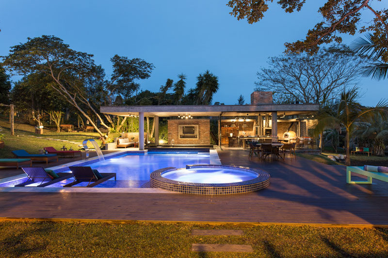 This Tropical Pool House Has A Swim Up Bar And A Glass Enclosed Dining Area