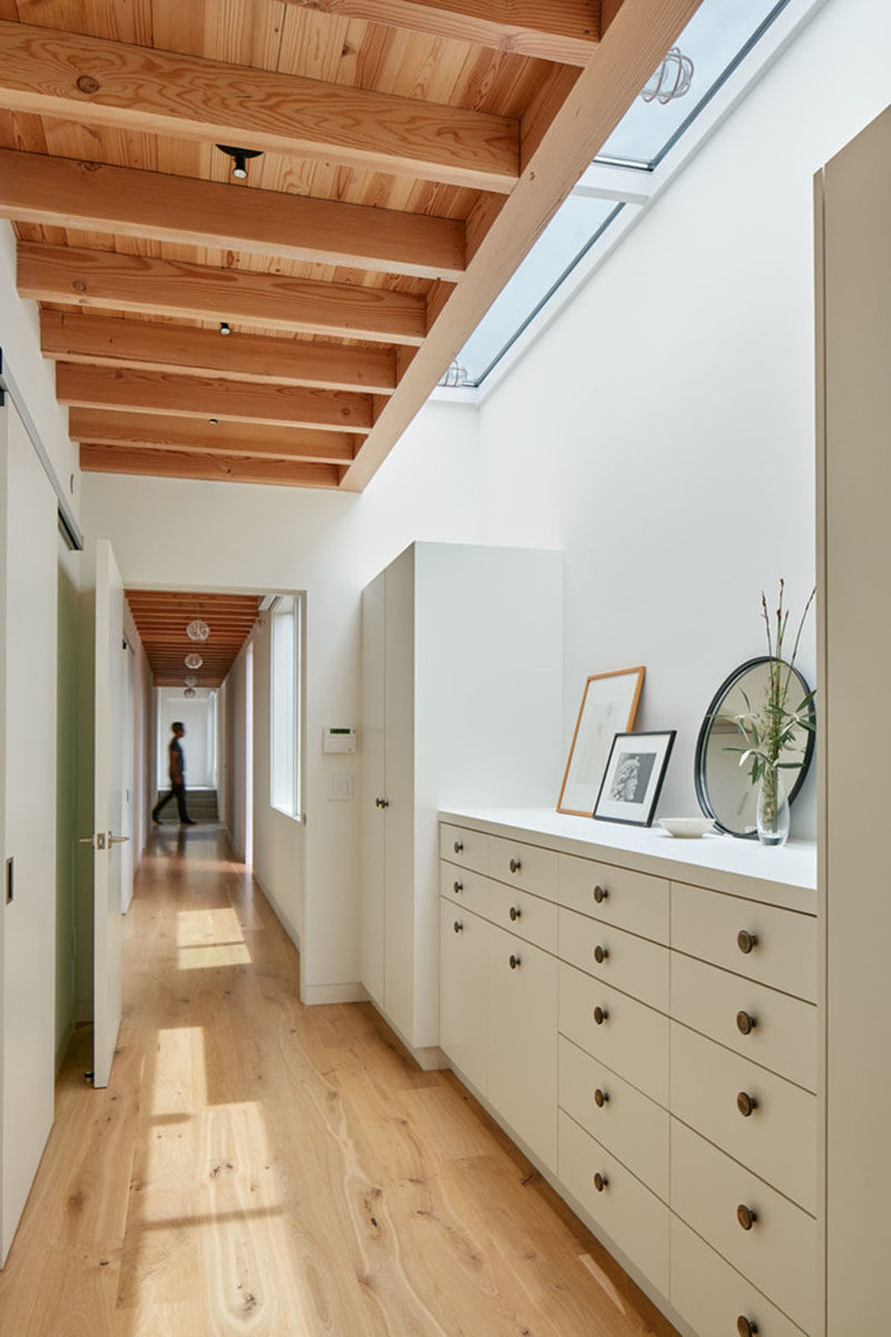 This master bedroom has its own vestibule with plenty of storage, and a skylight adds some natural light to the area.