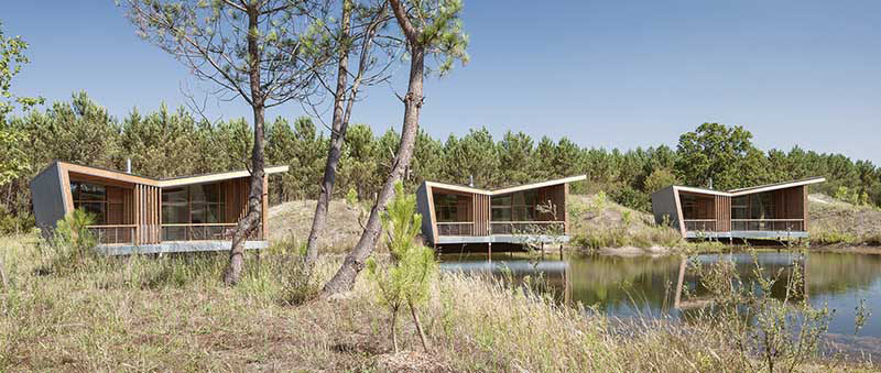 Patrick Arotcharen Architecte has designed a golf and surf eco-lodge in Saubion, France, named Les Echasses, where each of the private villas and restaurant have butterfly roofs.