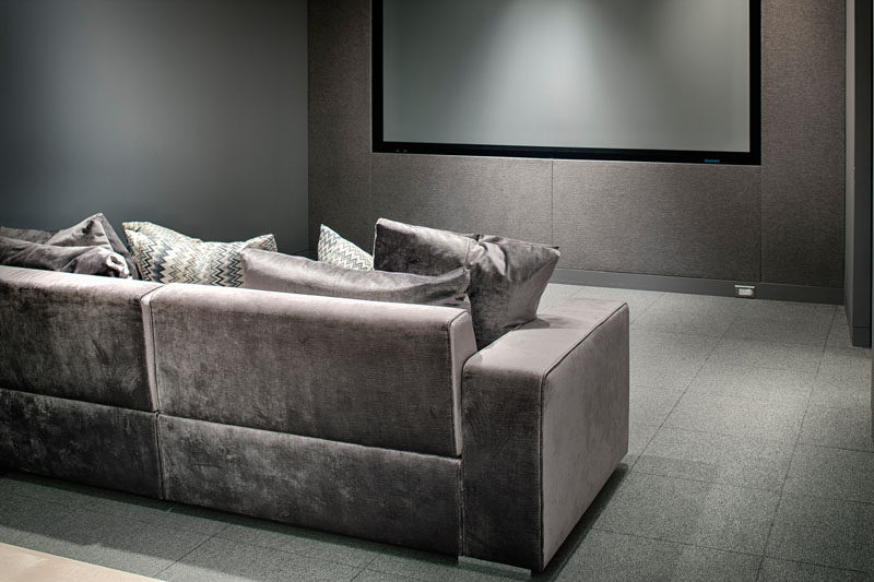 This home theater has a relaxing grey color palette.