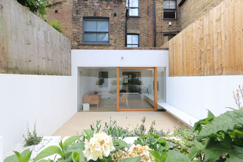 A Bright White Dining Room Extension And Landscaped Terraced Backyard Were Added To This East London Home