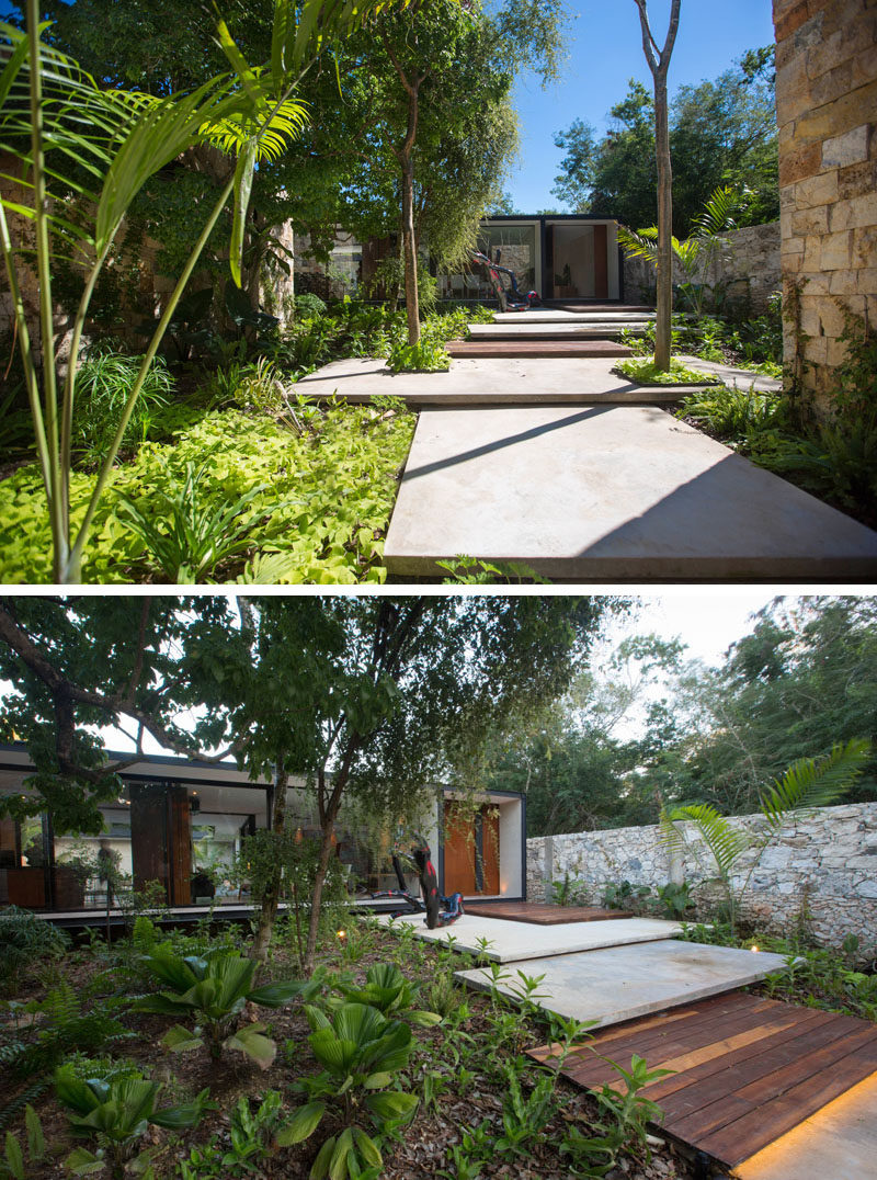 A stepped path made from wood and concrete, and surrounded by lush landscaping leads you from the garage to the main house.