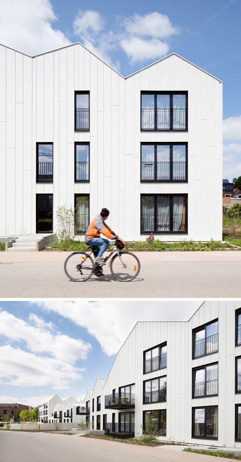 House Exterior Colors - 11 Modern White Houses From Around The World // Black window frames and balconies create a striking contrast against the white panels covering the exteriors of this row of houses.