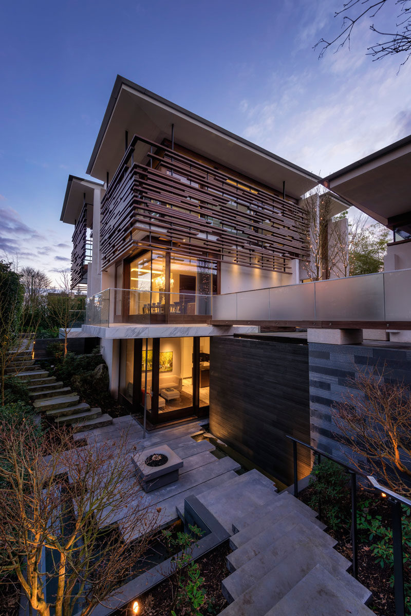 This outdoor area features a firepit surrounded by landscaping that leads to the garage and the front of the home.