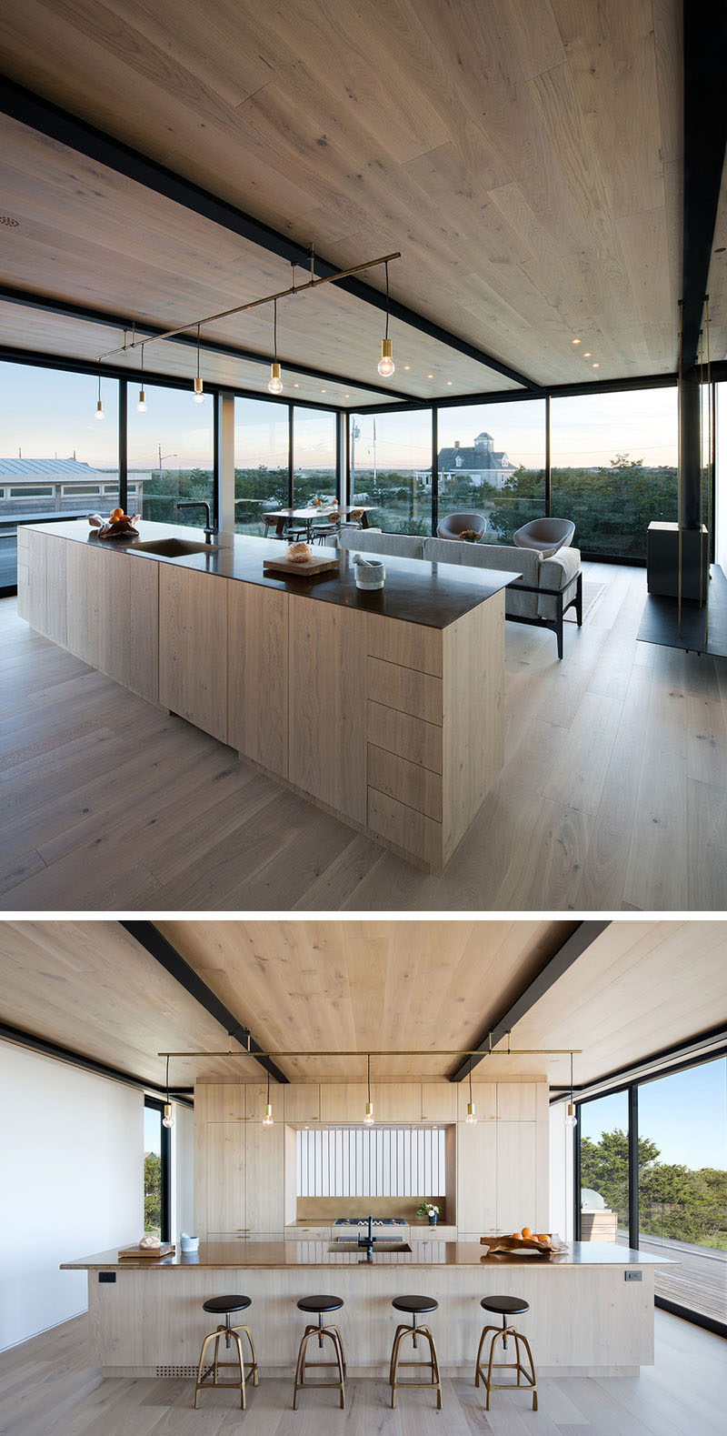 On the upper level of this home there's the living, dining and kitchen area. A large kitchen island with plenty of storage divides the space. On the right, a wood burning stove sits on a suspended steel shelf.