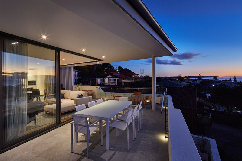 The balcony on this townhouse has been set up for outdoor dining, perfect for watching the sun set over the ocean.