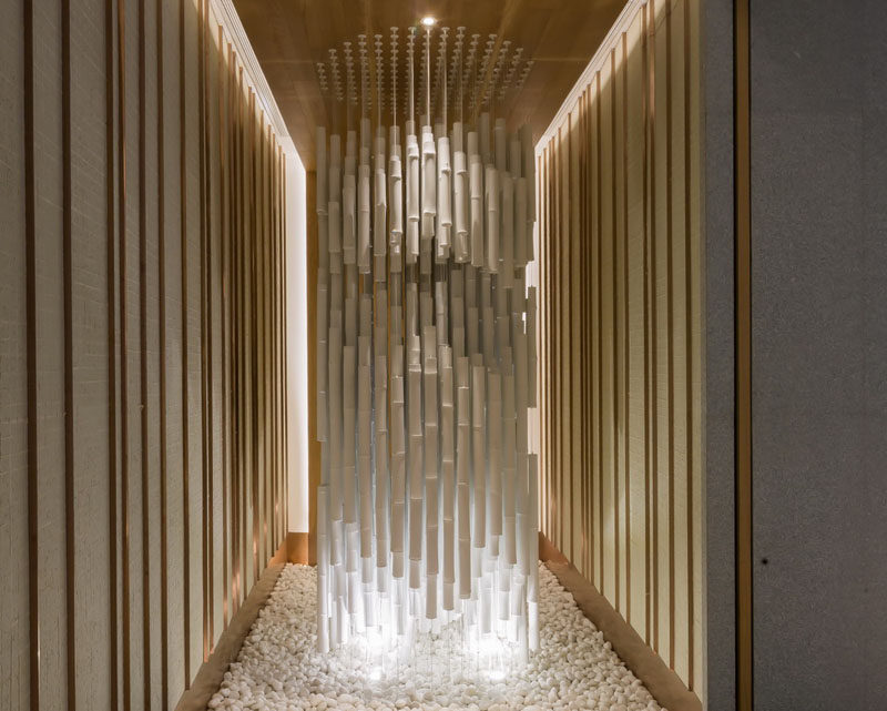 A sculptural installation of hanging bamboo and light fills a small space as you walk into this restaurant.