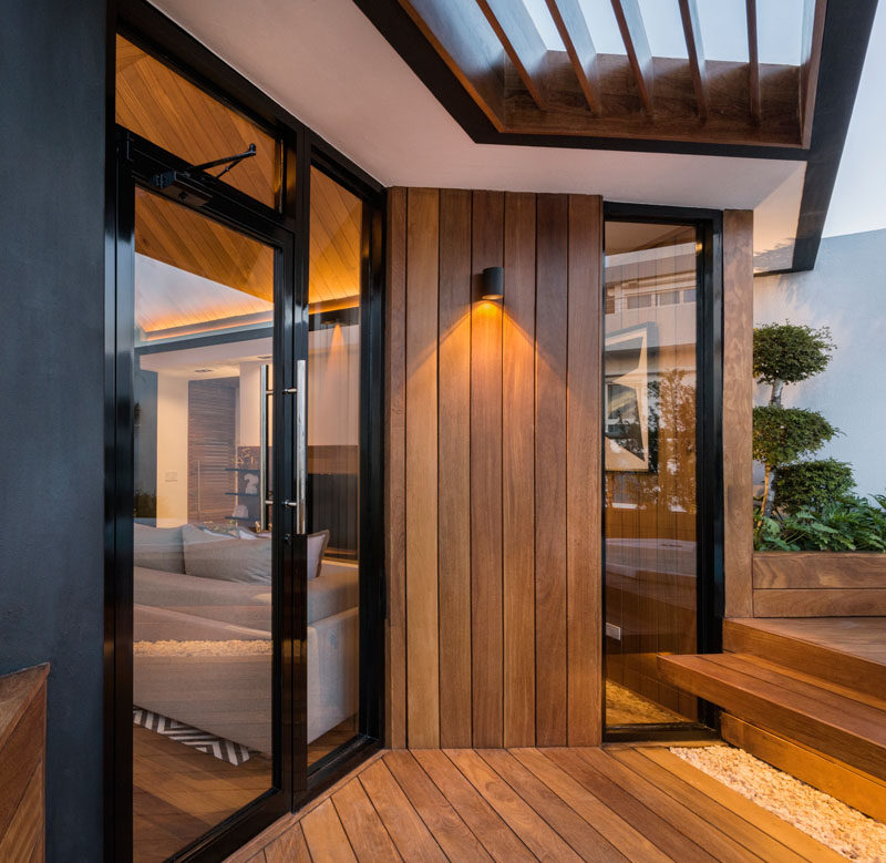 This rooftop terrace has wood siding that flows down to the deck of the outdoor area.