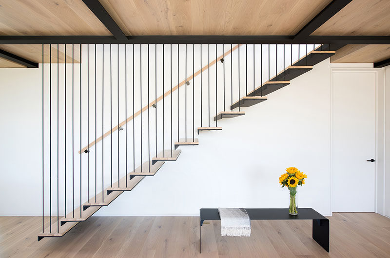 This staircase is strung from steel beams above, and the rods used to support each tread serve as guardrail for the stair.