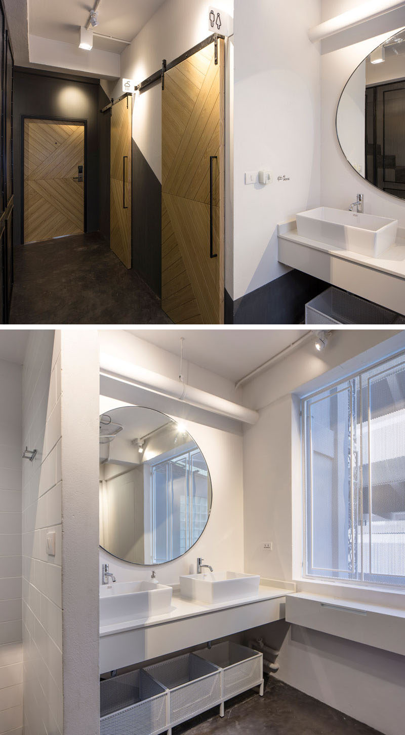 In this modern hostel in Bangkok, there's a washroom in each dormitory, with a shower, bathroom and vanity area.