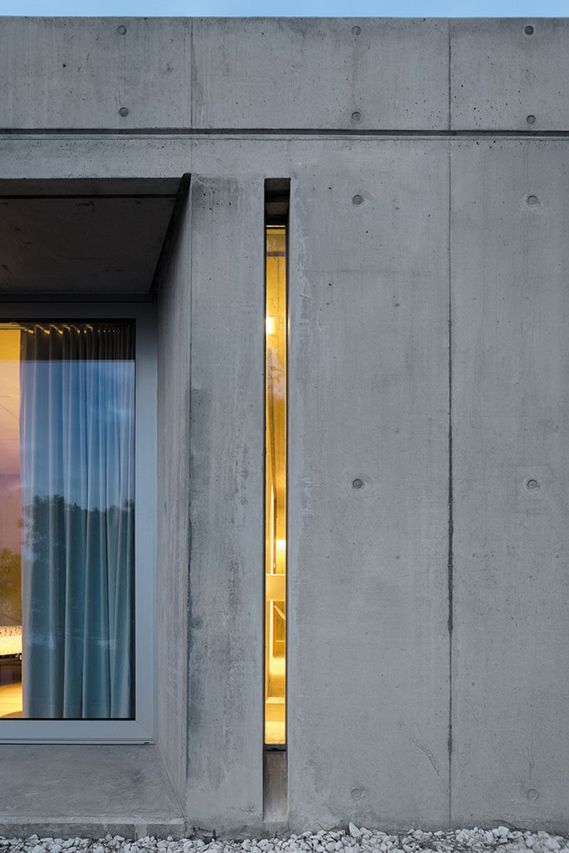 Window Style Ideas - Narrow Vertical Windows // This super narrow window lets just a sliver of light pass through to create a unique look on the exterior of this concrete home.