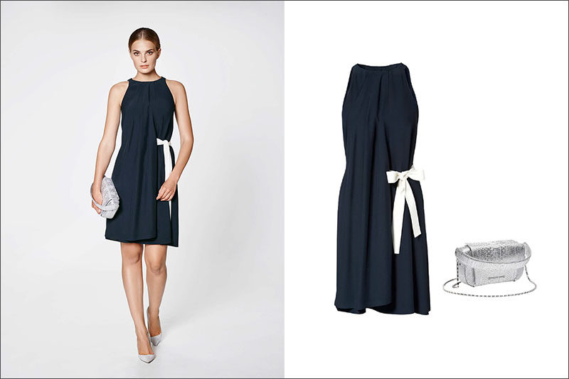 Women's Fashion Ideas - 12 Women's Outfits From Porsche Design's 2017 Spring/Summer Collection // A navy dress with a white side bow and a silver bag create this girly women's outfit.