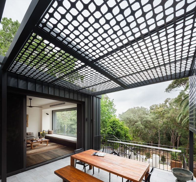 Raising up from the backyard of this house is an outdoor dining area located just off the living room.