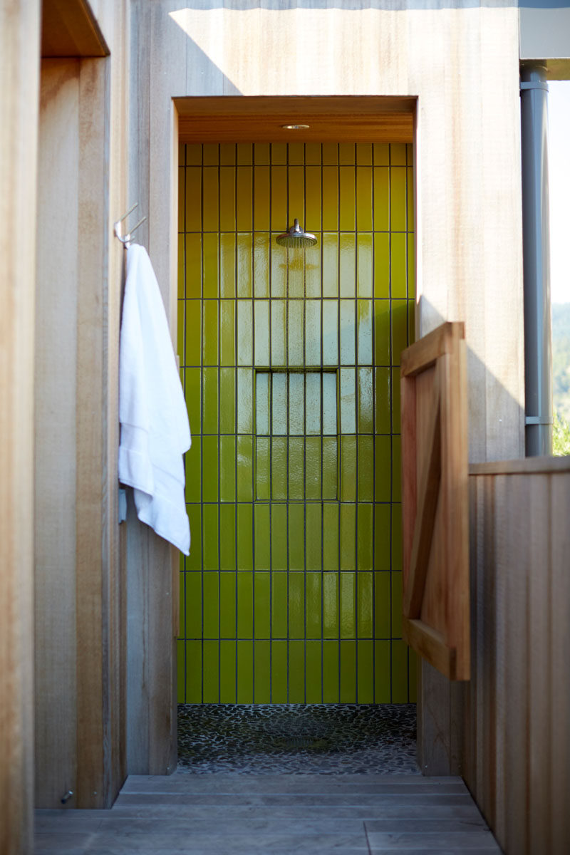 Bright lime green tile has been used in this outdoor shower.