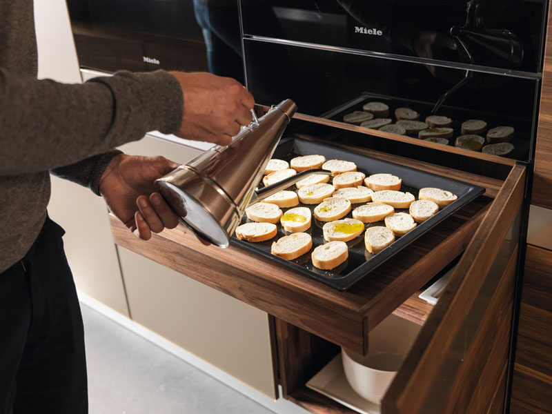 Kitchen Design Idea - Pull-Out Counters (10 Pictures) // A pull out counter installed right under the oven creates a convenient spot to do final prep before putting food into the oven.