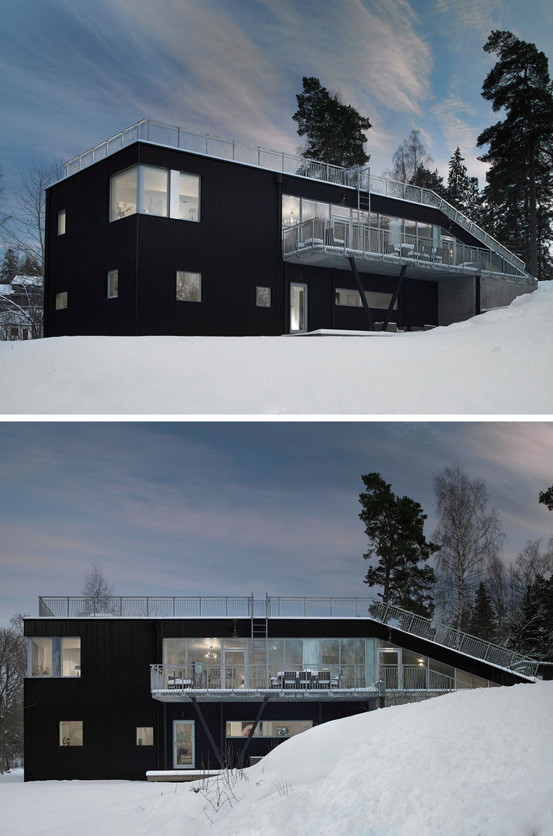 19 Examples Of Modern Scandinavian House Designs | The black metal siding that covers the exterior of this Swedish home makes the house stand out against the snow that covers the ground in the winter, and pop out from the greenery around it in the summer.