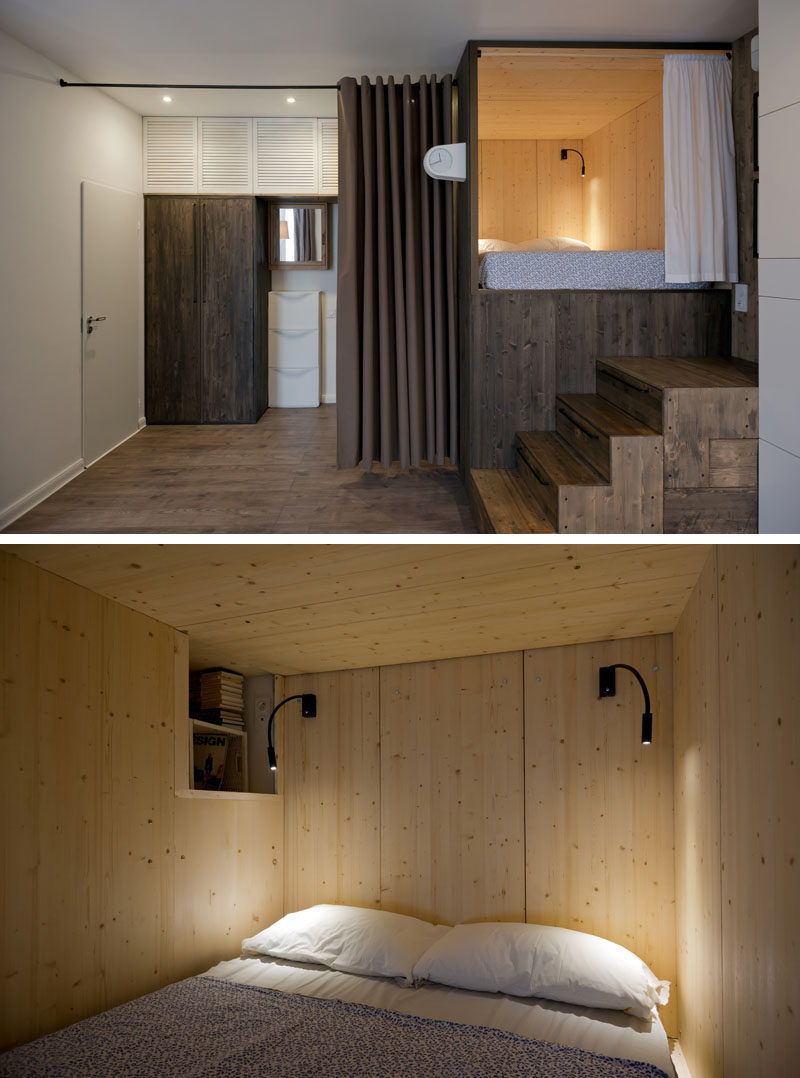 In this dark-stained pine raised bedroom, instead of having a bedside table, there's a small open shelf built into the box that surrounds the bed.