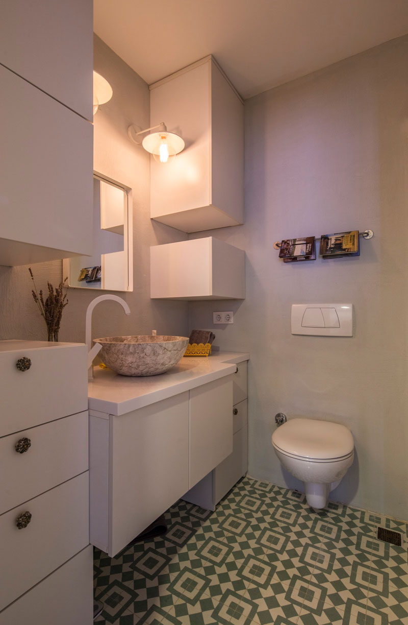 When designing this bathroom, the interior designers used the height of the room to create additional storage that reaches all the way to the ceiling.