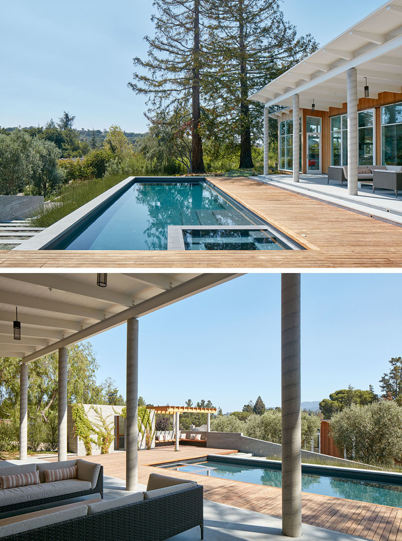 A wooden deck partially surrounds this swimming pool and provides various areas for lounging.