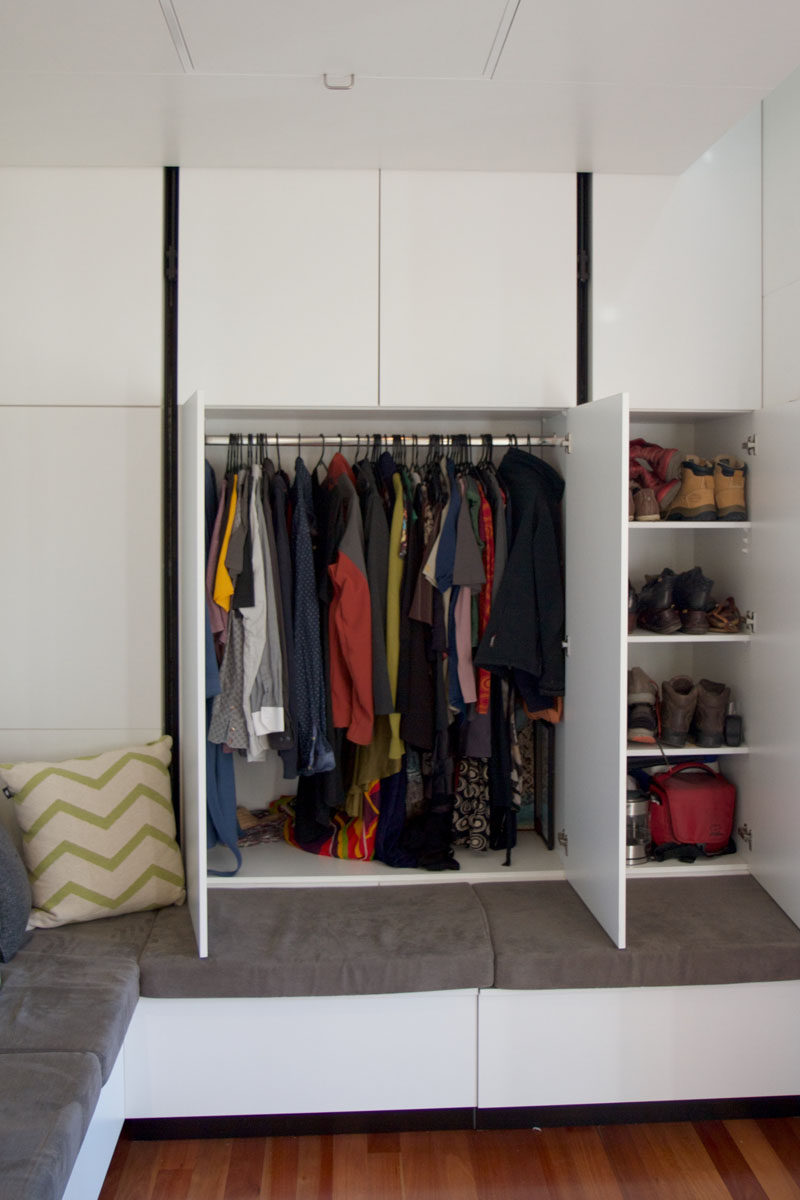 This wall in a tiny home has a closet hidden within it.