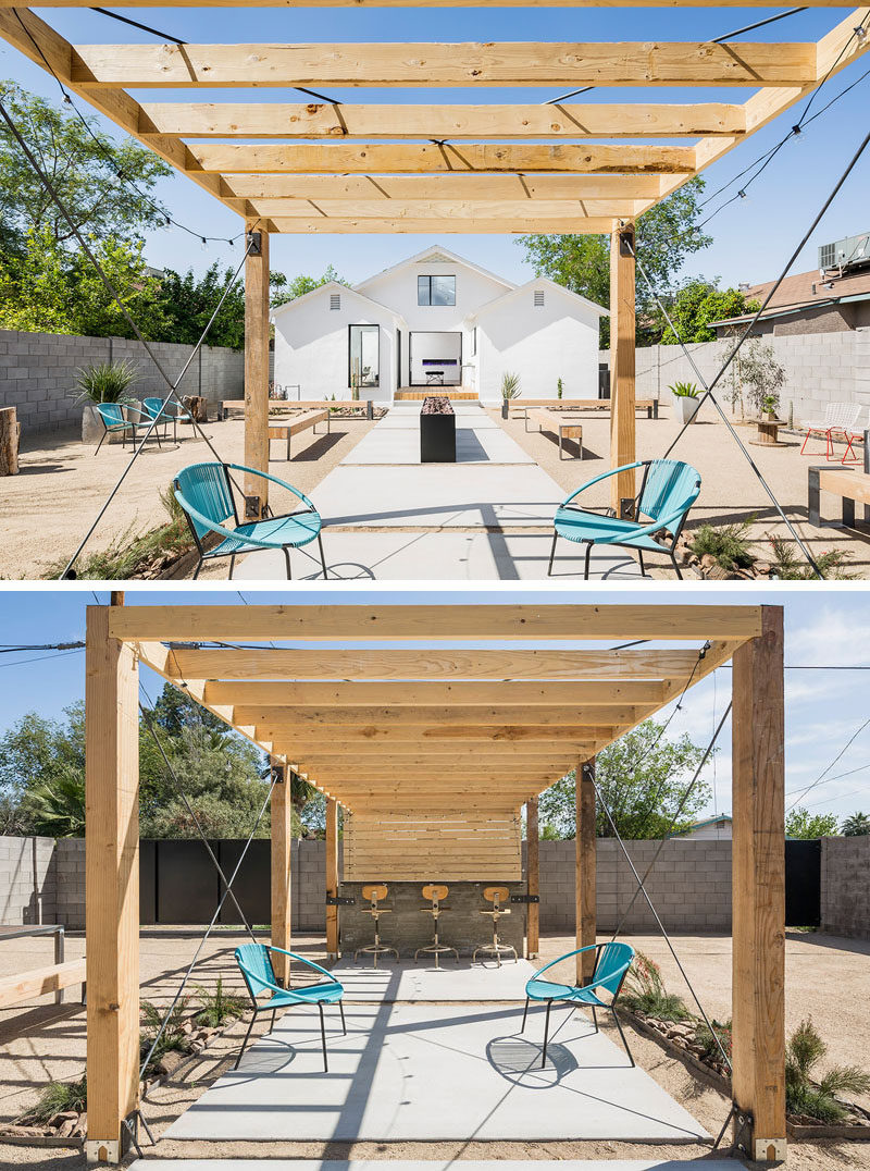 Landscaping Design Ideas - 11 Backyards Designed For Entertaining | This large backyard has tons of seating options, as well as a bar area underneath a pergola to create an ideal entertaining yard.