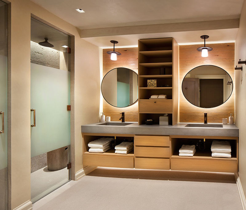 If you're designing a bathroom with double sinks, consider adding wood shelves in between to give each sink its own distinct space.