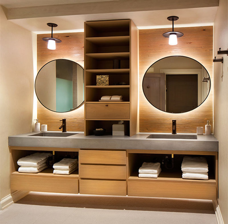 If you're designing a bathroom with double sinks, consider adding wood shelves in between to give each sink its own distinct space.