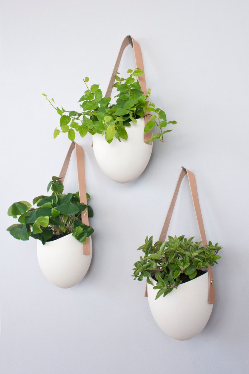 8 Bedroom Wall Decor Ideas // Hanging Wall Planters - Bring some life and color to your walls by hanging planters on them. You'll get the benefit of having cleaner air in the bedroom as well as the benefit of having your walls look super stylish.