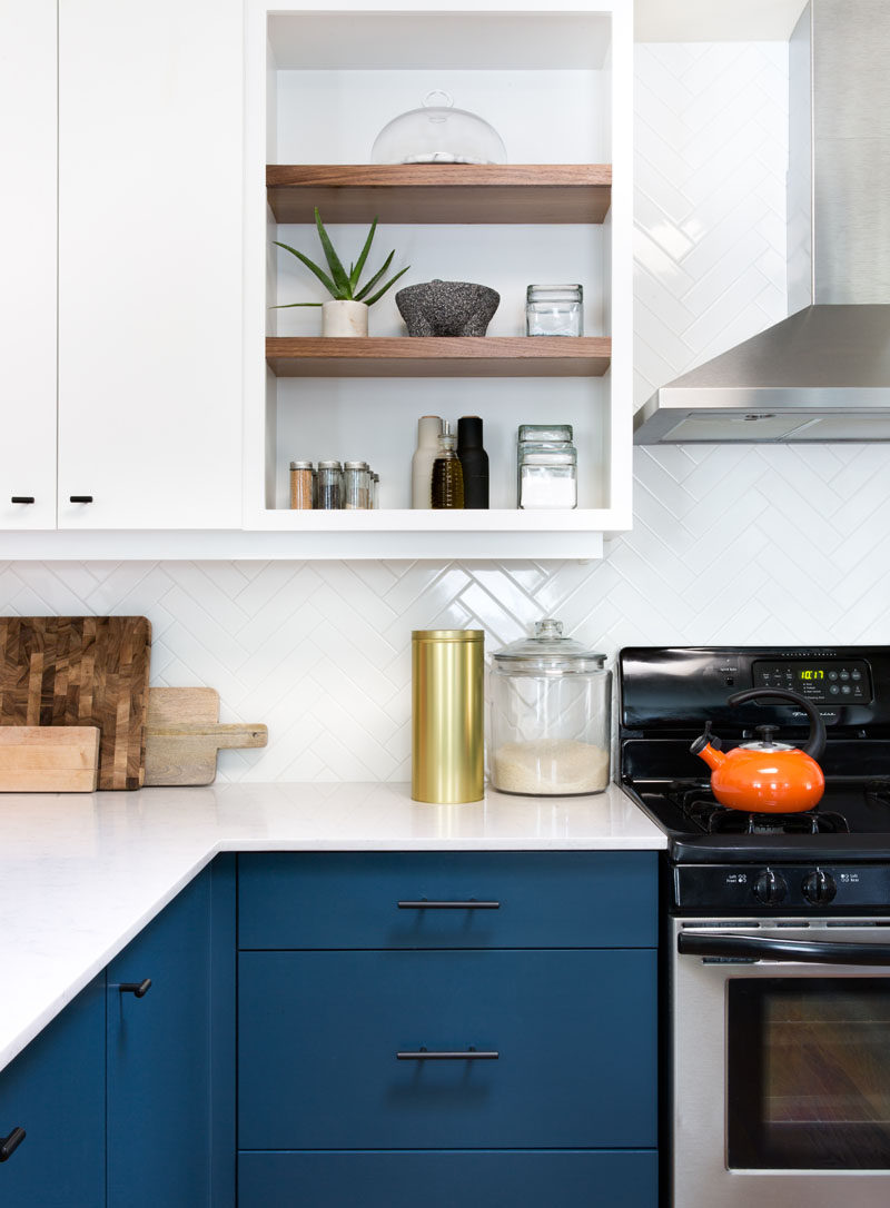 This Home In Austin Received An Updated White And Navy Blue Kitchen // A combination of open and closed shelving give the home owners freedom to display certain objects and keep the most frequently used herbs and spices easily accessible while hiding everything else out of sight.