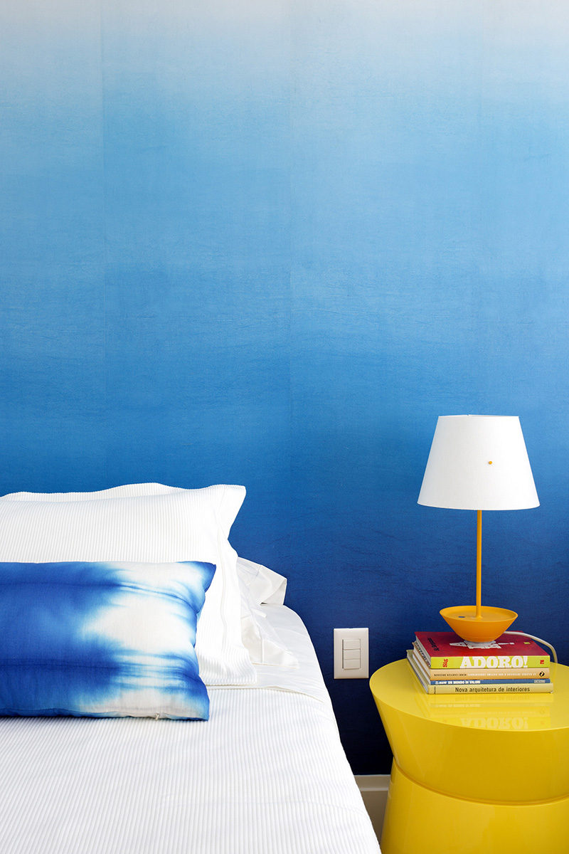 Bedroom Design Ideas - The designers of this apartment used an ombre wallpaper in the bedroom to create an accent wall that's stylish and less overpowering than a full blue wall. #BlueWall #BlueWallpaper #OmbreWall #BedroomDesign #ModernBedroom