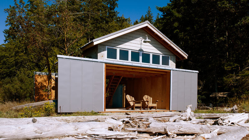 Seattle architects Hoedemaker Pfeiffer designed this modern boat house that features a loft sleeping area so that it can be used year round for both boat storage and overnight stays.