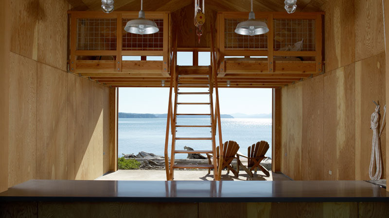 Seattle architects Hoedemaker Pfeiffer designed this modern boat house that features a loft sleeping area so that it can be used year round for both boat storage and overnight stays.