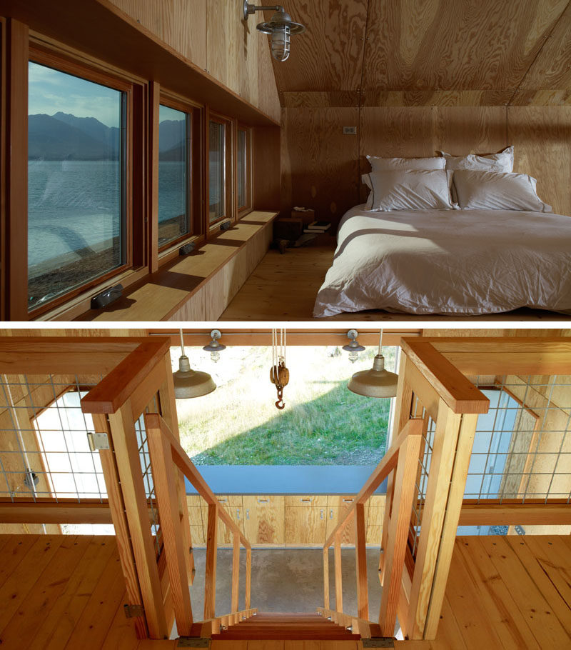 This modern boat house has a lofted sleeping area with six windows offering incredible views of the beach outside.